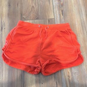 Pink shorts with elastic waistband and drawstrings.